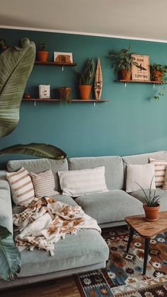 a living room filled with furniture and plants