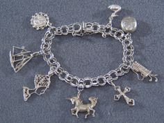 I am offering you this spectacular vintage sterling silver (tested positive for sterling silver 925 content) mixed themed charm bracelet. This is a loaded charm bracelet having 8 unique mixed theme charms . It is on a classic wide multi leveled linked charm bracelet , the previous owner had several years of collecting here !! One is an actual locket that opens, that has room for 2 pictures. It measures app. 7 inches long , and is app. 1 3/4 inches at it widest dangle point. It weighs app. 30 gra Unique Sterling Silver Charm Bracelet Gift, Symbolic Dangle Charm Bracelet, Antique Style Bracelets With Dangling Charms As Gift, Antique Bracelets With Dangling Charms As Gift, Antique Bracelets With Dangling Charms For Gift, Silver Symbolic Bracelets With Dangling Charms, Symbolic Silver Bracelets With Dangling Charms, Symbolic Silver Bracelet With Dangling Charms, Collectible Symbolic Charm Jewelry