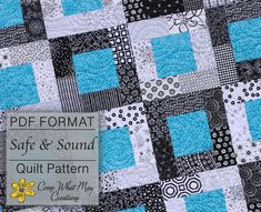 a blue and black quilt with white squares on the front, and an information card attached to it