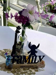 the table is set with flowers and personalized items for guests to use as centerpieces