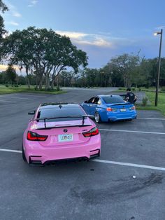 two cars parked in a parking lot next to each other