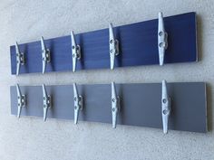 four blue and gray surfboards mounted to the wall next to each other with hooks on them