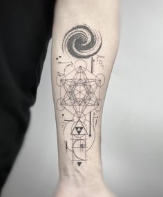 a person with a tattoo on their arm that has geometric shapes and lines all over it