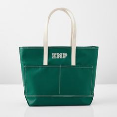 an emp green bag with white handles and two zippered pockets on the front