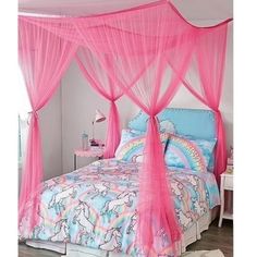 a pink canopy bed with unicorns on it