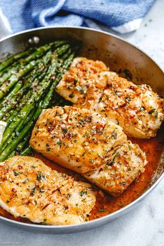 chicken and asparagus in a pan with seasoning