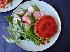 two plates with food on them, one has meat and the other has radishes