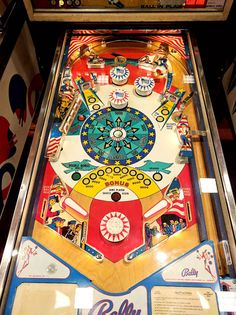 an old fashioned pinball machine with many different colors and designs on the front panel