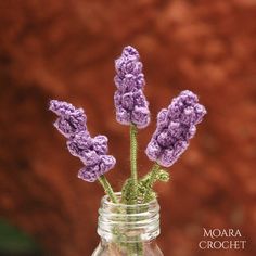 purple crocheted flowers in a mason jar