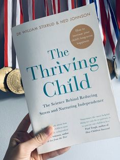 the thriving child by dr william strudd and ned johnson holding up a book