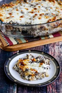 a casserole dish on a plate with a fork next to the casserole