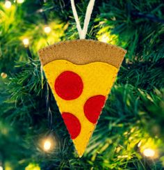 a felt pizza slice ornament hanging from a christmas tree