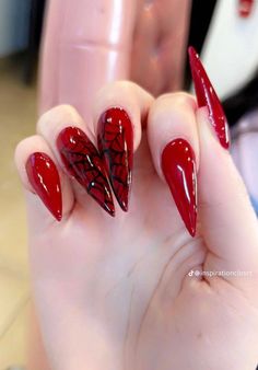 a woman's hand with red and black nails