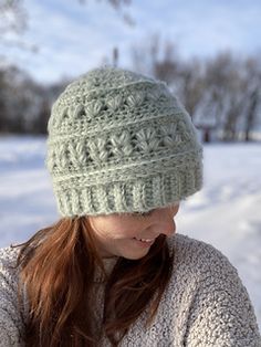 a woman wearing a knitted hat in the snow