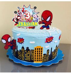 a spiderman themed birthday cake on a table