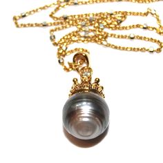 "This is a gorgeous natural striped grey baroque Tahitian pearl pendant necklace has a tiny gold plated tiara with a cubic zirconia. The pearl drop is suspended from a 18\" gold vermeil chain with silver squares. Tres chic! xoxoxo payton For more cool jewelry looks, check out http://www.etsy.com/shop/FizzCandy All FizzCandy creations come beautifully boxed and ready for gift giving." Luxury Gold Jewelry With Tahitian Pearls, Luxury Gold Tahitian Pearl Jewelry, Gold Tahitian Pearl Jewelry With Pearl Charm, Gold Tahitian Pearl Pendant Necklace, Elegant Gold Tahitian Pearl Necklaces, Elegant Gold Tahitian Pearl Necklace, Tahitian Pearl Round Pendant Necklace For Gift, Yellow Gold Tahitian Pearl Drop Necklace, Formal Gold Necklace With Tahitian Pearl