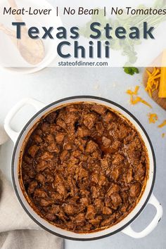 a large pot filled with meat and cheese next to other food on a counter top