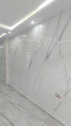 an empty room with marble floors and walls