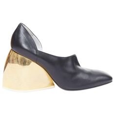 LOEWE gold curved heel black leather slip on heeled shoes EU39 Reference: ECLO/A00130 Brand: Loewe Designer: JW Anderson Collection: Runway Material: Leather, Metal Color: Black, Gold Pattern: Solid Closure: Slip On Lining: Black Leather Extra Details: Gold curved chunky heels. Made in: Italy CONDITION: Condition: Good, this item was pre-owned and is in good condition. Please refer to image gallery for thorough condition check. Multi scratches and stains on gold heels. Natural worn dents at top. SIZING Designer size: EU39 Size reference: EU39 / US9 / UK6 / JP26.5 This Loewe item is authentic. Loewe Shoes, Gold Heels, Jw Anderson, Gold Pattern, Jil Sander, Leather Slip Ons, Image Gallery, Giuseppe Zanotti, Black Heels