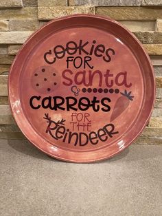 a pink plate that says cookies for santa and carrots for the reindeer