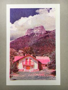 an old photo of a house with mountains in the background and clouds above it that are pink