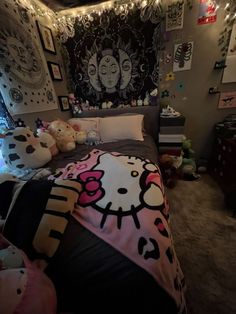 a bedroom with hello kitty decorations and lights on the wall above the bed is decorated in pink, black and white