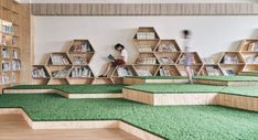 the children's library is filled with bookshelves and green carpeted floors