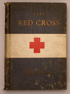 an old book with a red cross on the front and white stripe down the middle