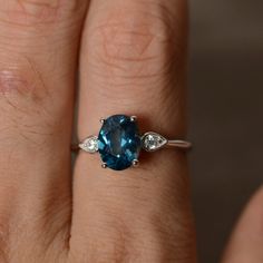 This is a gorgeous handmade creation. Its beauty is its simplicity & Elegance. The 7*9mm oval cut London blue topaz is crafted in solid sterling silver and with rhodium plated. All item is sent in a beautiful gift box You can realize more lovely stuff clicking the link https://www.etsy.com/shop/knightjewelry?refshopsection_shophome_leftnav Please leave the correct address and you phone number for delivering successfully. Classic Oval Topaz Ring, Classic Oval Topaz Birthstone Ring, Oval Blue Topaz Ring In Fine Jewelry Style, Oval Blue Topaz Ring Fine Jewelry, 14k White Gold Oval Topaz Ring, Fine Jewelry Oval Blue Topaz Ring, Oval Topaz Birthstone Ring In Sterling Silver, Oval Blue Topaz Ring In White Gold, Oval White Gold Topaz Birthstone Ring