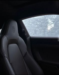 the interior of a car with black leather and white stitching on the front seats