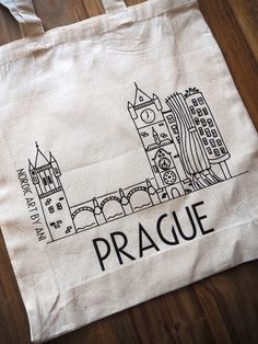 Reusable 100% cotton tote bag with handmade design of Prague Czech. The perfect tote can hold anything from books to groceries and it is durable enough to use over and over again.  And with its timeless minimalistic style it can be taken pretty much anywhere from school, the farmers market, a park or to the beach. Size 28 x 42 x 10 cm          14.9 x 16.5 x 3.9 inches Hand wash (20 oC / 68 oF) and iron inside out. Personalizations are possible, please contact me for more informations. Minimalistic Style, Prague Czech, Cotton Tote Bag, Handmade Design, Cotton Totes, Cotton Tote Bags, Prague, Farmers Market, Purses And Handbags