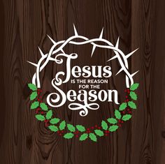 the words jesus is the reason for the season on a wooden background with holly wreath