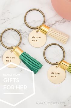 three gold and green tasseled key chains with the words dance mom, gift for her