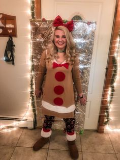 a woman in a reindeer costume standing next to a door