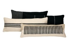 four black and white striped pillows stacked on top of each other