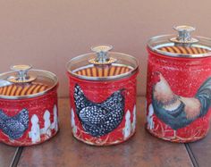 three canisters with rooster designs on them