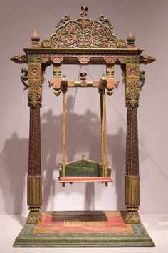 an elaborately decorated wooden stand on display in a museum