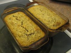 two pans filled with food sitting on top of a stove