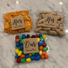 three bags filled with different types of candies on top of a marble countertop