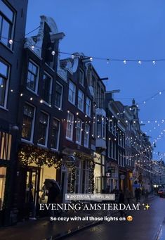 a city street is lit up with christmas lights