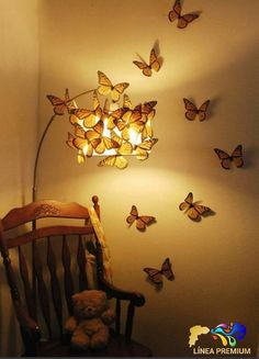 a teddy bear sitting in a chair next to a lamp and butterflies on the wall