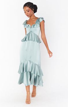 Feminine and flirty, this silver sage ruffled tiered midi dress is as romantic as they come. The ruffles and flutter sleeves make this dreamy dress the utmost flattering, and smocked back ensures the perfect fit. Slate Blue Bridesmaid Dresses, Satin Ruffle Dress, Mint Green Bridesmaid Dresses, Ruffles Bridesmaid Dresses, Teal Bridesmaid Dresses, Silver Bridesmaid Dresses, Sage Bridesmaid Dresses, Formal Wedding Guest Dress, Sage Green Bridesmaid Dress