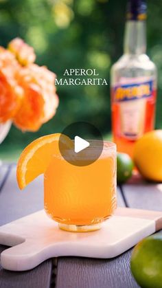 an image of a drink on a table with lemons and limes