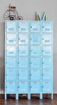 a large blue locker sitting next to a bike on top of a hard wood floor