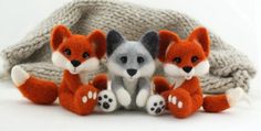 three stuffed foxes sitting next to each other