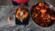 there are many fruits in the bowl on the table and one is peeled oranges