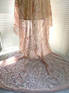 Alaina BLUSH PINK IRIDESCENT Curlicue Sequins on Mesh Lace Fabric by the Yard - 10018 Content: 100% polyester Stretch: 4-way Width: 50 to 52 inches Edge: Straight Uses: Wedding/evening gowns, formal wear, dresses, tops, skirts, decorations, costumes, apparel accents/appliqué crafts, etc. DISCLAIMER: Expedited shipping options do not apply to 5, 10, 50 and 100 yard options. Sample/Swatch: 4x2 inches for $4.99 each, free shipping. We highly suggest buying a sample first to see and feel the fabric Pink Embroidered Fitted Sequin Fabric, Pink Iridescent, Formal Wear Dresses, Discount Fabric, Stretch Velvet, Evening Gowns Formal, Cut And Color, Lace Fabric, Dance Wear