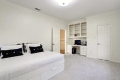 a bedroom with white walls and carpeted flooring