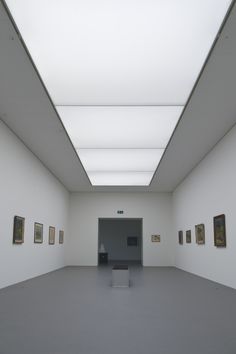 an empty room with paintings on the walls