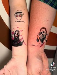 two people with matching tattoos on their arms, one is holding the other's hand